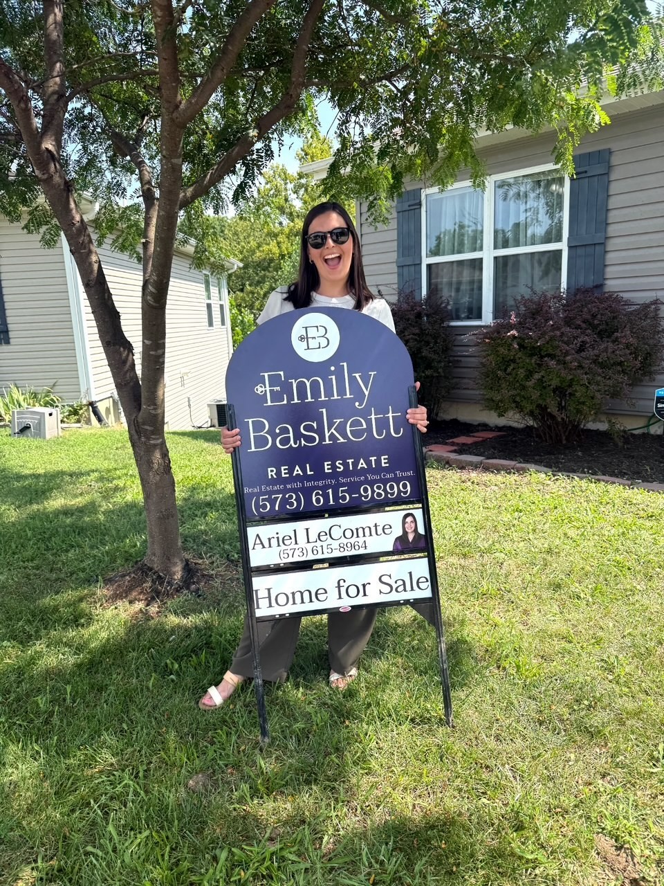 Emily Baskett Real Estate agent with a Home for Sale sign in Columbia, MO