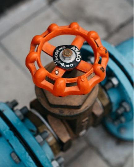 Orange main water shutoff valve on a home's pipes
